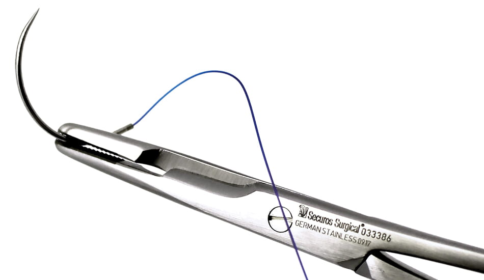 premium sutures between surgical scissors